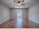 Spacious room featuring a ceiling fan, hardwood floors, and light paint at 26608 E Cove Dr, Tavares, FL 32778