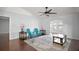 Bright living room with wood floors, ceiling fan, archways, and two blue chairs at 26608 E Cove Dr, Tavares, FL 32778