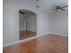 Bright open room with hardwood floors, neutral paint, and ceiling fan at 26608 E Cove Dr, Tavares, FL 32778