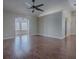 Spacious living room with wood flooring, open to other rooms, and neutral walls at 26608 E Cove Dr, Tavares, FL 32778