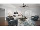 Bright and airy living room featuring a modern sofa, stylish decor, and an open layout at 26608 E Cove Dr, Tavares, FL 32778