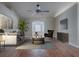 Bright and airy living room with hardwood floors, modern furniture, ceiling fan and an arched doorway at 26608 E Cove Dr, Tavares, FL 32778