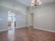 Open floor plan features hardwood floors and arched doorways to the kitchen at 26608 E Cove Dr, Tavares, FL 32778
