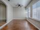 Bright living room featuring hardwood floors, ceiling fan, and lots of natural light at 26608 E Cove Dr, Tavares, FL 32778