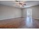 Spacious living room with hardwood floors, light paint, and ceiling fan at 26608 E Cove Dr, Tavares, FL 32778
