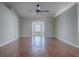 Spacious living room features hard wood floors, ceiling fan and an arched doorway at 26608 E Cove Dr, Tavares, FL 32778