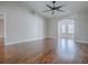 Bright living room with wood flooring, fan, and view to the next room at 26608 E Cove Dr, Tavares, FL 32778