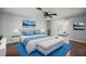 Bright main bedroom with a comfortable bed, scenic wall art, and a connecting sitting room at 26608 E Cove Dr, Tavares, FL 32778