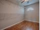 Empty walk-in closet with hardwood flooring, shelving, and neutral paint at 26608 E Cove Dr, Tavares, FL 32778