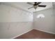 Walk-in closet featuring wooden floors, a ceiling fan, and multiple wire shelves at 26608 E Cove Dr, Tavares, FL 32778