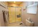 Cozy bathroom with frosted glass shower doors, neutral tones, and window blinds at 2682 Edwards Ln, The Villages, FL 32162