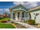 Inviting front porch with white picket fence, decorative walkway, and colorful garden at 27004 Nature View St, Leesburg, FL 34748