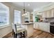 Kitchen area with breakfast bar, stainless steel appliances, granite counters and backyard view at 27004 Nature View St, Leesburg, FL 34748