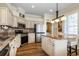 Well-equipped kitchen featuring stainless steel appliances, custom cabinetry, and center island at 27004 Nature View St, Leesburg, FL 34748