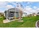 The screened-in patio includes colorful seating for relaxing in the backyard at 27004 Nature View St, Leesburg, FL 34748