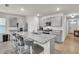 Modern kitchen island with granite countertop, gray cabinetry and stainless steel appliances at 28026 Cypress Springs Loop, Okahumpka, FL 34762