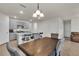 Open-concept kitchen with a breakfast bar, gray cabinets, and a view into the dining area at 28026 Cypress Springs Loop, Okahumpka, FL 34762