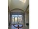 Lovely, light filled lobby with high ceilings, a round table, and a vase of flowers in the entryway at 28026 Cypress Springs Loop, Okahumpka, FL 34762