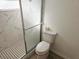 Modern bathroom featuring a walk-in shower with black and white tiles, and a clean, white toilet at 301 Clark St, Maitland, FL 32751