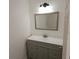 Bathroom features a gray vanity with modern mirror and lighting fixture at 301 Clark St, Maitland, FL 32751