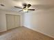 Bedroom showcases closet, neutral walls, and ceiling fan with light at 301 Clark St, Maitland, FL 32751