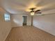 Bedroom features neutral walls, tile floors, window, and ceiling fan with light at 301 Clark St, Maitland, FL 32751