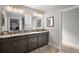 Bathroom featuring an extra-long vanity with double sinks, granite countertops, and modern lighting at 3261 Wise Way, The Villages, FL 32163