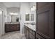 Modern bathroom with double vanities, granite countertops, and dark wood cabinets at 3261 Wise Way, The Villages, FL 32163