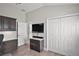 Well-lit bedroom with built-in storage, closet space, a desk, and views to the entry hall and front door at 3261 Wise Way, The Villages, FL 32163