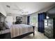 Comfortable bedroom featuring a ceiling fan, large window, and dark wood bedroom furniture at 3261 Wise Way, The Villages, FL 32163