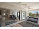 Relaxing screened-in patio with ceiling fans, plush seating, and seamless transition to the home's living area at 3261 Wise Way, The Villages, FL 32163