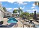 Sparkling private pool surrounded by lush landscaping, comfortable seating, and stylish patio furniture for ultimate relaxation at 3261 Wise Way, The Villages, FL 32163