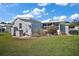 Exterior view of the home with a well-maintained lawn, mature landscaping, and storage shed at 3323 Manatee Rd, Tavares, FL 32778