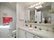 Bathroom featuring a vanity with a sink, a toilet, decorative walls, and a large mirror at 3323 Manatee Rd, Tavares, FL 32778