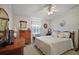 Bedroom featuring wood furnishings, white walls, and serene ambiance for relaxation and comfort at 3323 Manatee Rd, Tavares, FL 32778