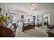 Cozy bedroom with floral bedding, mirrored closet, and ample natural light creates a serene and inviting atmosphere at 3323 Manatee Rd, Tavares, FL 32778