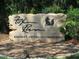 Stone sign for Fox Run, a resident owned 55+ community, nestled amongst lush trees at 3323 Manatee Rd, Tavares, FL 32778