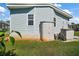 Side exterior view of the home featuring storage sheds and well-manicured lawn at 3323 Manatee Rd, Tavares, FL 32778