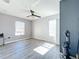 Bedroom with ceiling fan, two windows and wood-style flooring at 339 Winter Nellis Cir, Winter Garden, FL 34787