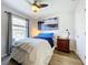 Cozy bedroom featuring ceiling fan, natural light, and wood-style floors at 339 Winter Nellis Cir, Winter Garden, FL 34787