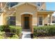 Inviting front entrance with a green door, manicured bushes, and a concrete walkway at 339 Winter Nellis Cir, Winter Garden, FL 34787