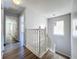 Upstairs hallway with wood-style flooring, chandelier, and natural light at 339 Winter Nellis Cir, Winter Garden, FL 34787