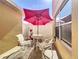 Cozy patio featuring an umbrella, table, and two chairs at 339 Winter Nellis Cir, Winter Garden, FL 34787