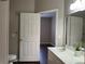 Well-lit bathroom with tiled floors and a doorway to bedroom at 3605 Conroy Rd # 535, Orlando, FL 32839