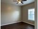 Cozy bedroom features a ceiling fan and a large window allowing natural light at 3605 Conroy Rd # 535, Orlando, FL 32839