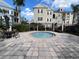 Community hot tub surrounded by lush greenery and a small fence at 3605 Conroy Rd # 535, Orlando, FL 32839