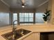 Bright kitchen with stainless steel sink, white cabinets, and natural light at 3605 Conroy Rd # 535, Orlando, FL 32839