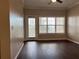 Living room featuring hardwood floors with view to a fenced outdoor area at 3605 Conroy Rd # 535, Orlando, FL 32839