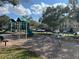 Community playground featuring swings and a slide with building in background at 3605 Conroy Rd # 535, Orlando, FL 32839