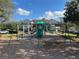 Community playground featuring swings and a slide with building in background at 3605 Conroy Rd # 535, Orlando, FL 32839